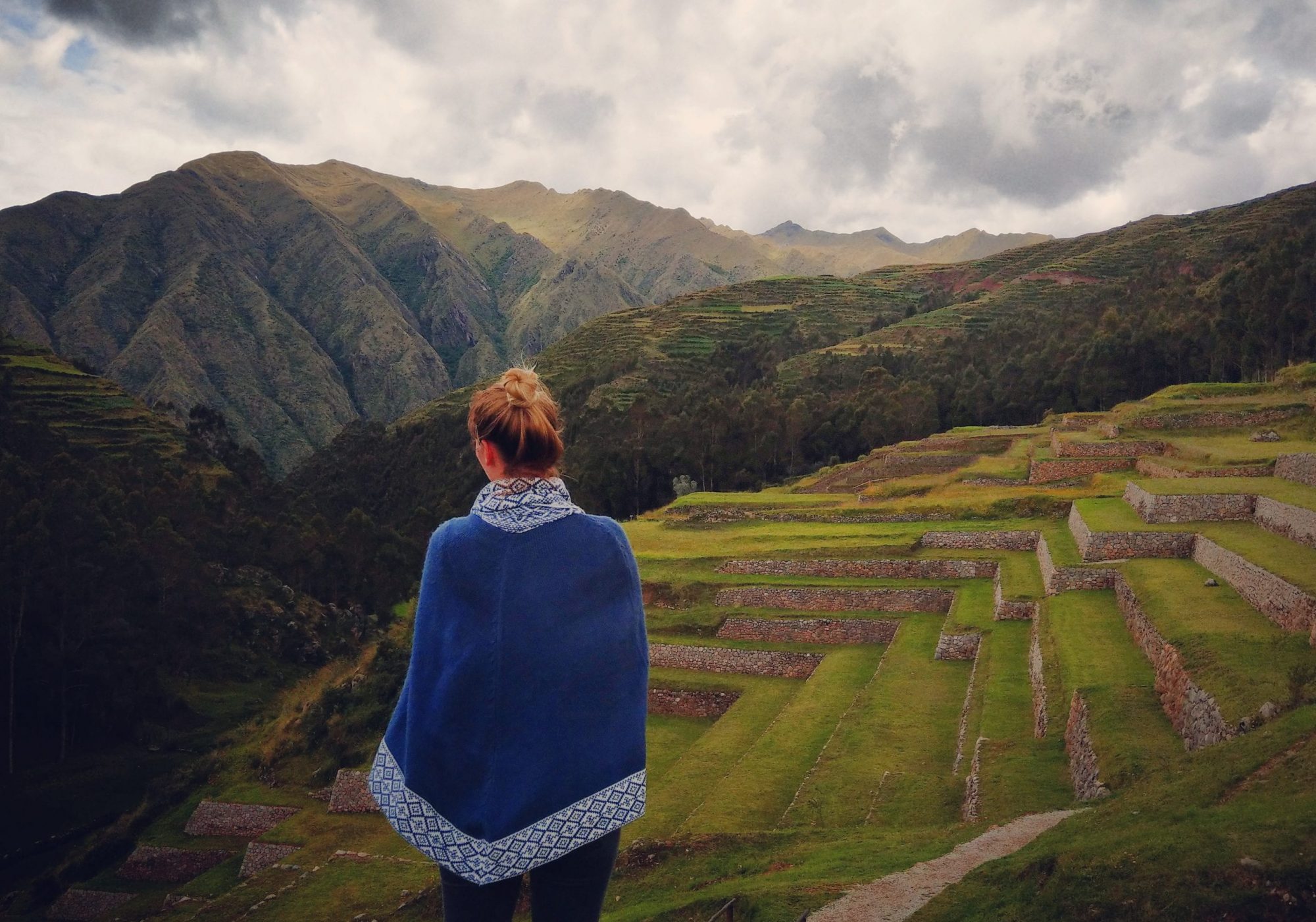Girl in front of Inca ruins, Peru